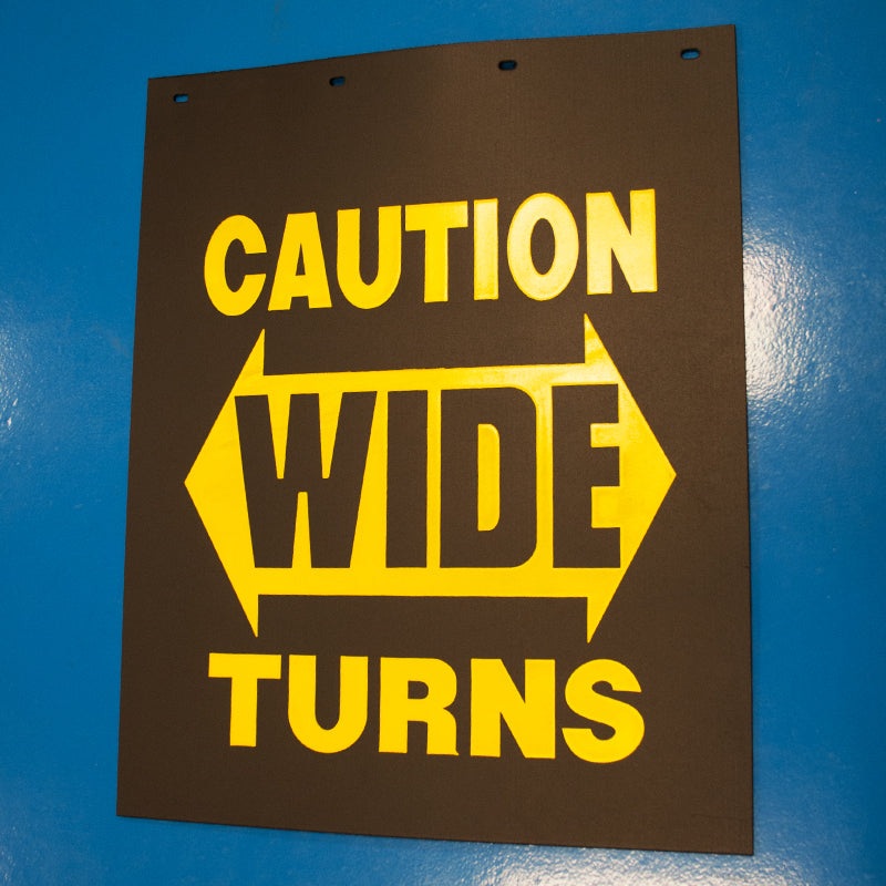 Caution Wide Turn 24 x 30 black poly mudflap w/yellow logo